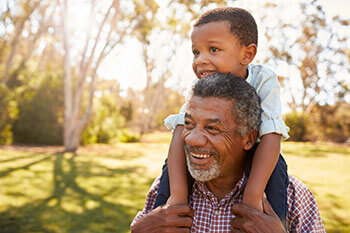 Older man playing with grandson after Glaucoma Surgery