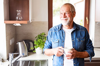 Older man smiling after being treated for Macular Degeneration 